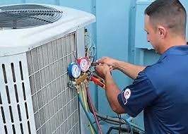 Technician checking pressure gauges on an outdoor cooling unit